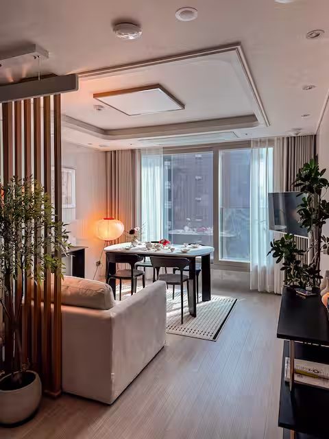 Living room with forest and city view